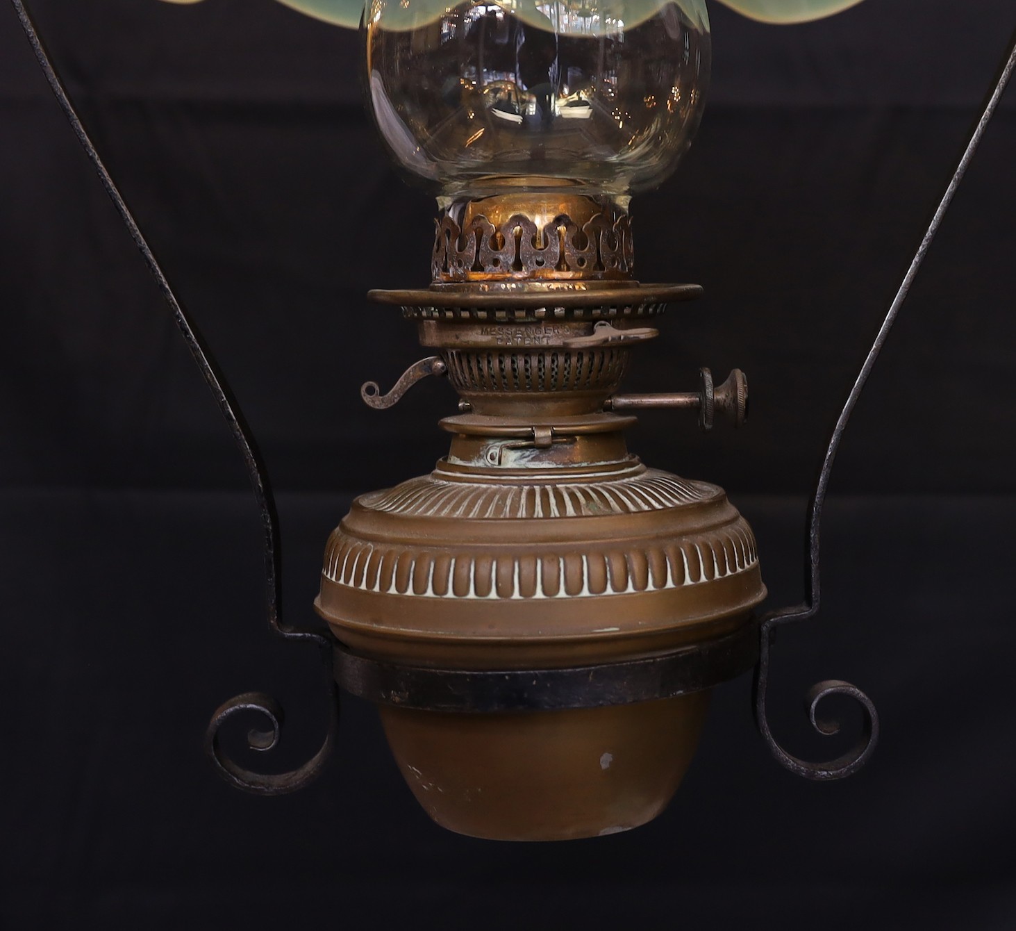 An English Arts & Crafts wrought iron and brass hanging oil lamp with Messengers mechanism and frilled Vaseline glass shade, height 86cm. diameter 40cm